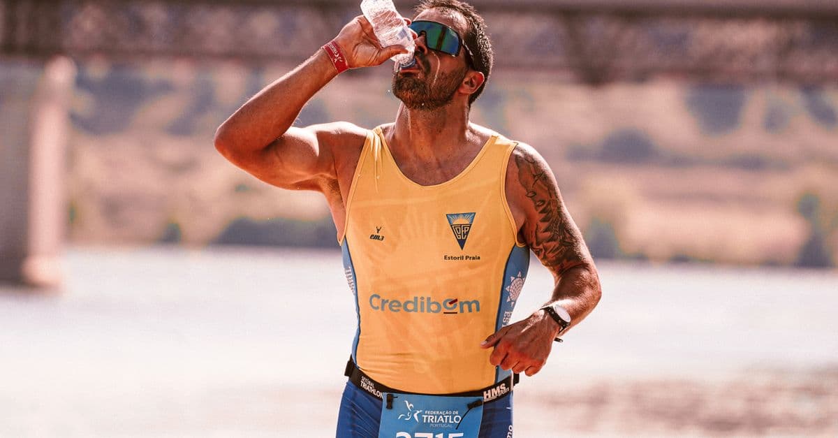 Runner drinking water outdoors in hot weather